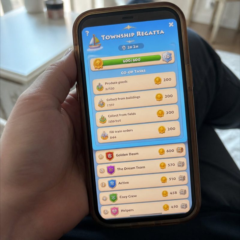 Township Regatta screen showing co-op task list with coin re